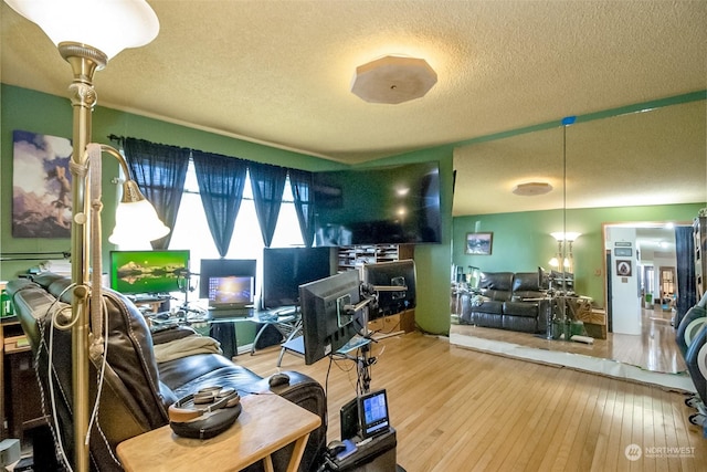 home office with wood-type flooring and a textured ceiling