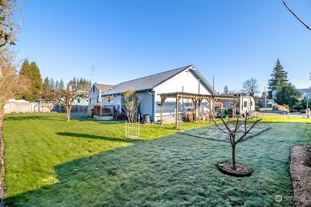 exterior space featuring a wooden deck, a pergola, and a lawn