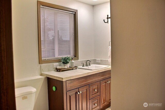 bathroom with vanity and toilet