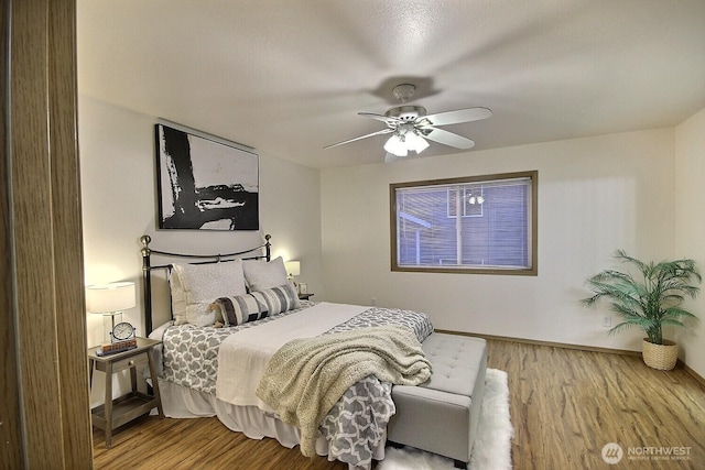 bedroom with wood-type flooring and ceiling fan