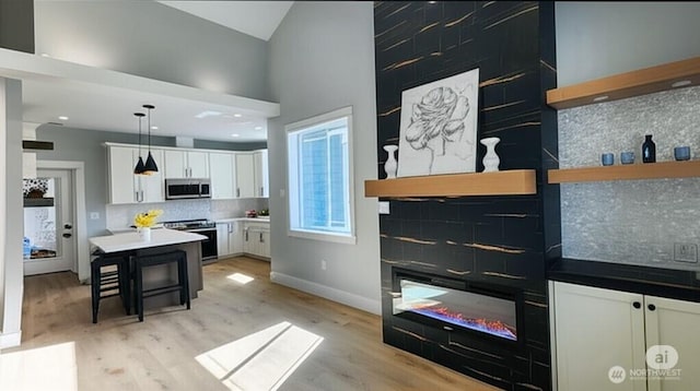 998 Cascade Ave SW, Ocean Shores, WA 98569 - kitchen featuring appliances with stainless steel finishes, open shelves, backsplash, white cabinets, and recessed lighting