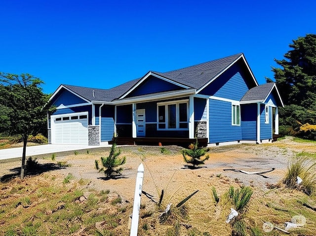 998 Cascade Ave SW, Ocean Shores, WA 98569 - ranch-style house featuring concrete driveway, a garage, a porch, and a shingled roof