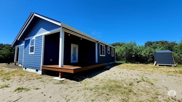 998 Cascade Ave SW, Ocean Shores, WA 98569 - view of side of home with crawl space, a wooden deck, and an outbuilding