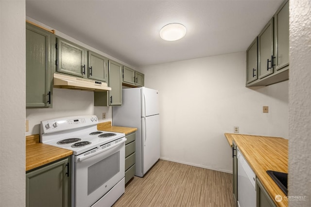 kitchen featuring white appliances, green cabinets, and light wood-type flooring