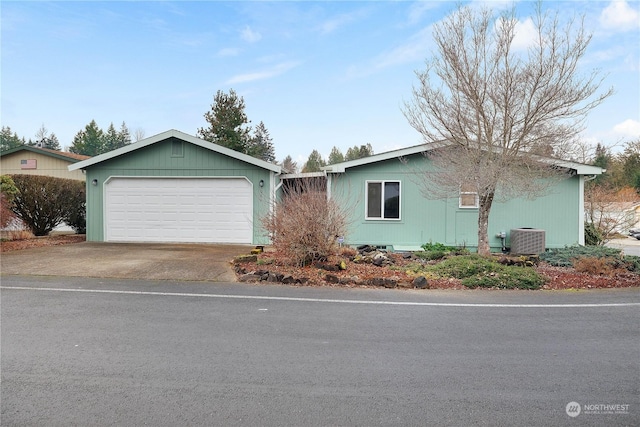 ranch-style home featuring a garage and central AC