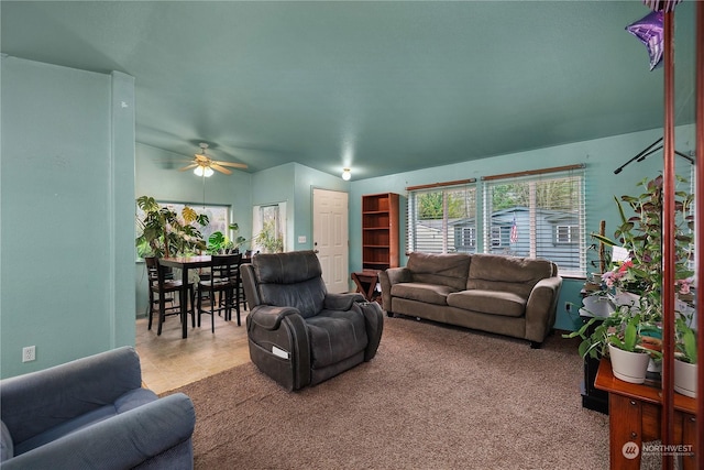 carpeted living room with ceiling fan