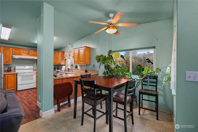 dining room with ceiling fan and lofted ceiling