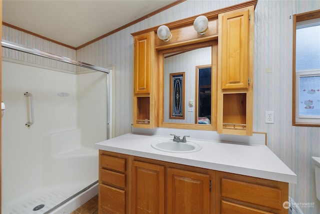 bathroom with crown molding, an enclosed shower, and vanity