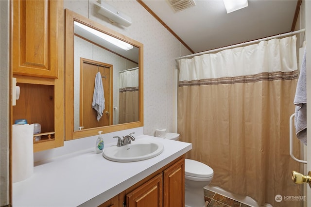 bathroom featuring toilet, crown molding, vaulted ceiling, vanity, and tile patterned flooring