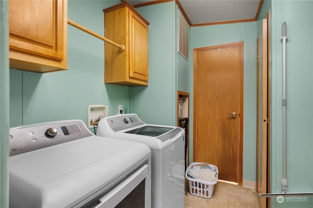 laundry area with cabinets, crown molding, and washing machine and clothes dryer