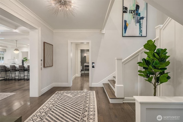 entrance foyer featuring a chandelier, dark wood-type flooring, baseboards, stairway, and crown molding