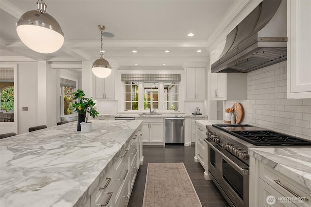 kitchen with stainless steel appliances, white cabinetry, wall chimney range hood, and light stone counters