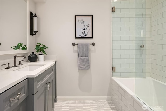 full bath featuring baseboards, tiled shower / bath, and vanity