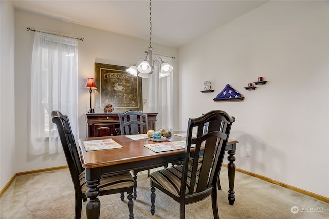 dining area featuring light carpet