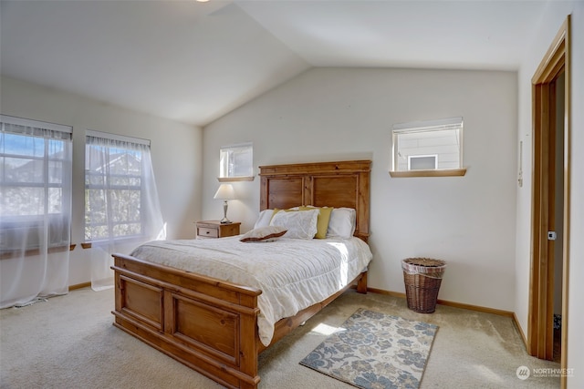 bedroom with lofted ceiling and light colored carpet