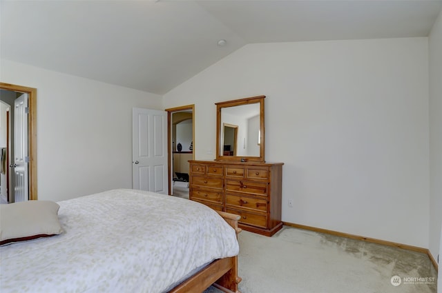 carpeted bedroom with vaulted ceiling