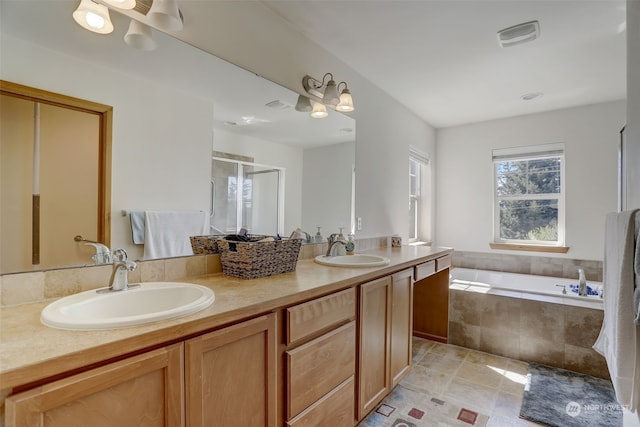 bathroom with shower with separate bathtub and vanity