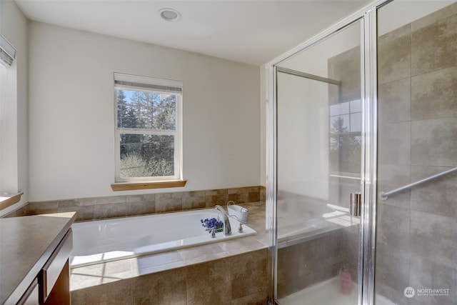 bathroom featuring vanity and shower with separate bathtub