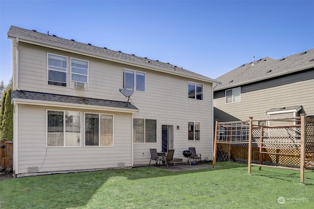 rear view of property featuring a yard