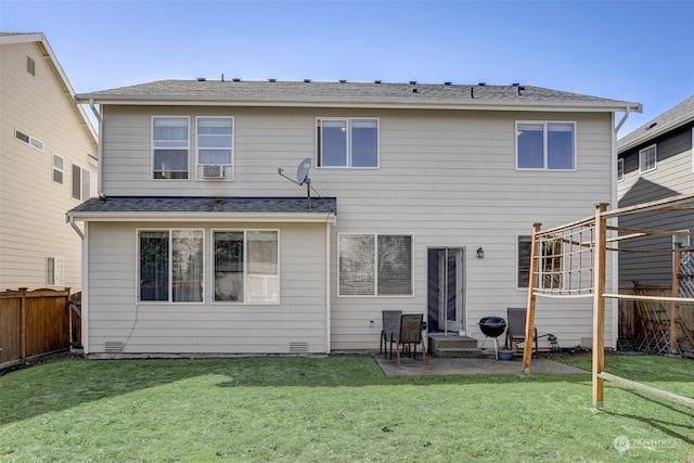 rear view of property with a lawn and a patio