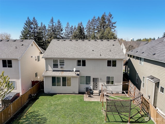 rear view of property with a lawn and a patio area