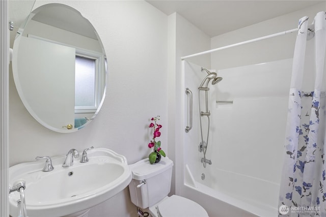 full bathroom featuring toilet, shower / bath combo, and a sink