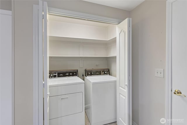 washroom featuring washer and clothes dryer and laundry area