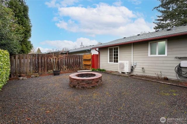 exterior space with ac unit, an outdoor fire pit, and fence