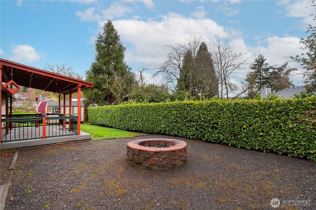 view of patio featuring a wooden deck and an outdoor fire pit