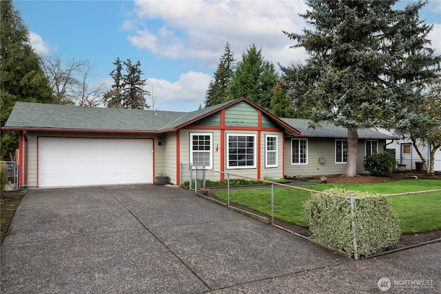 single story home featuring concrete driveway, fence, a garage, and a front yard