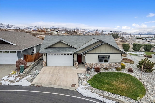 ranch-style home with a garage and a mountain view