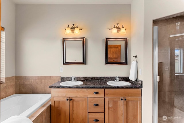 bathroom featuring separate shower and tub and vanity