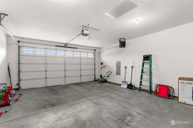 garage with a garage door opener and electric panel