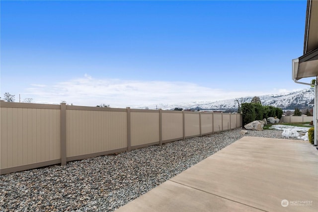 view of yard featuring a mountain view and a patio