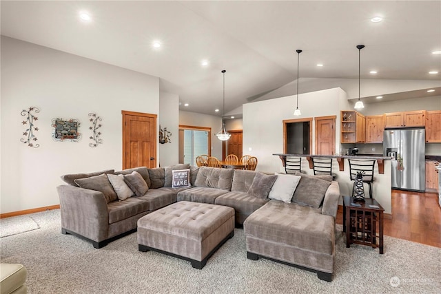 carpeted living room featuring lofted ceiling