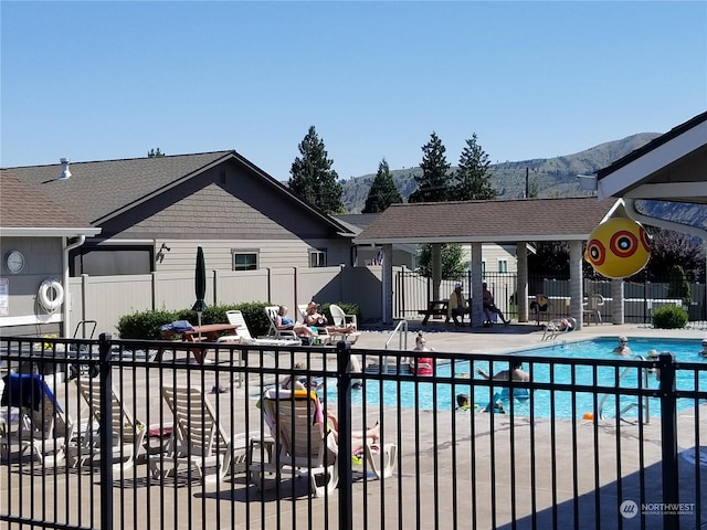 view of pool with a mountain view and a patio