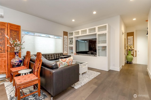 living room with built in shelves and dark wood-type flooring