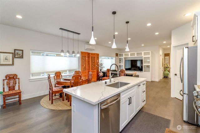 kitchen with white cabinetry, a kitchen island with sink, sink, pendant lighting, and stainless steel appliances