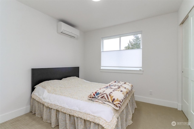 bedroom with a closet, a wall mounted AC, and light carpet