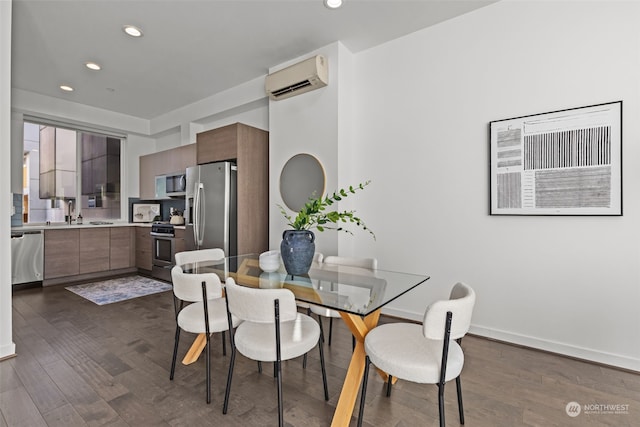 dining room featuring sink, dark hardwood / wood-style floors, and a wall mounted air conditioner