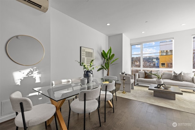 dining space featuring an AC wall unit and hardwood / wood-style floors