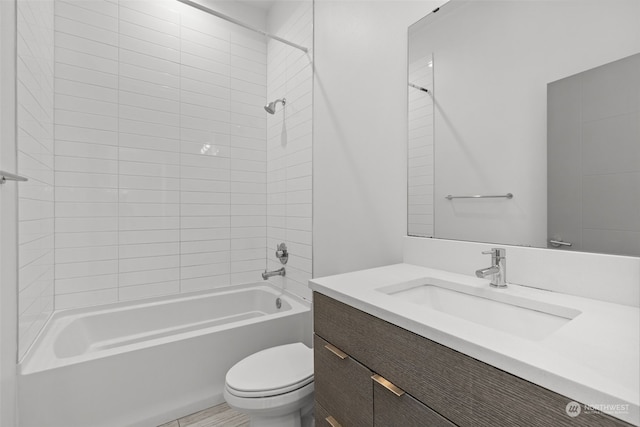 full bathroom featuring toilet, vanity, and tiled shower / bath