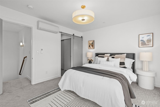 carpeted bedroom with a wall mounted air conditioner and a barn door