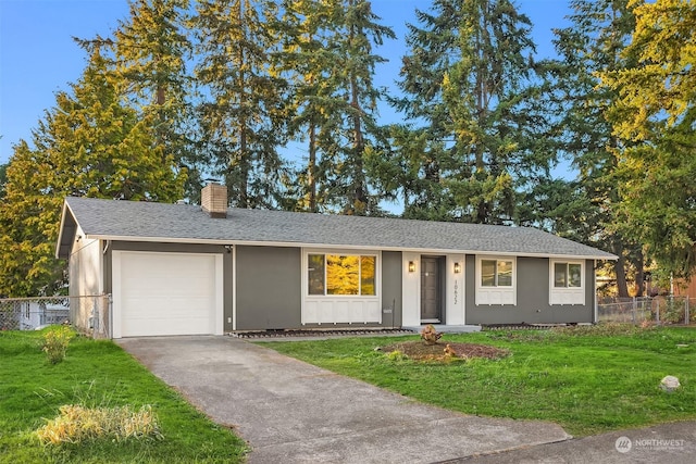 ranch-style home with a garage and a front lawn