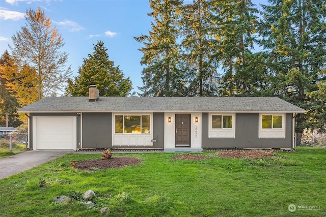 ranch-style home with a garage and a front yard