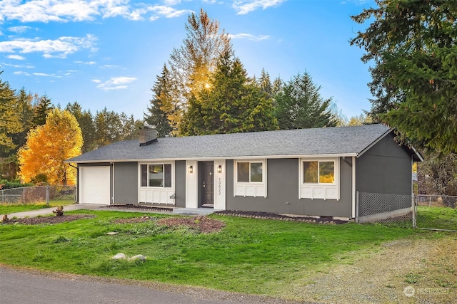 ranch-style home featuring a garage and a front lawn