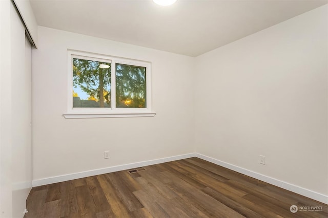 spare room with hardwood / wood-style flooring