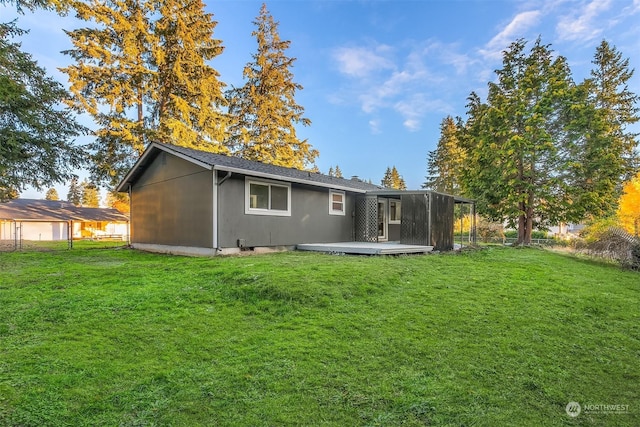 rear view of house with a yard