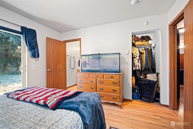 bedroom with hardwood / wood-style floors and a closet