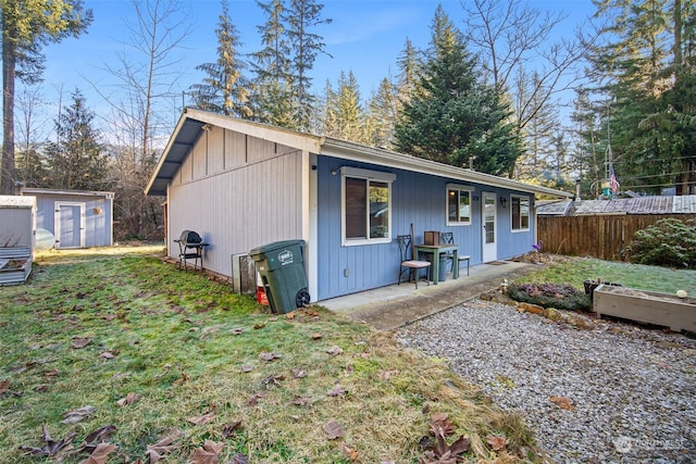 exterior space with a lawn and a storage unit